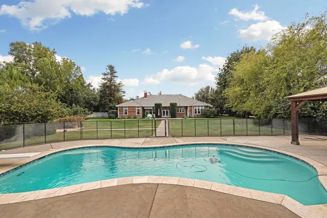 an aerial view of residential houses with outdoor space and street view