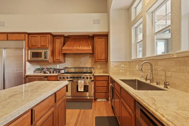 a view of a kitchen with sink dryer and windows