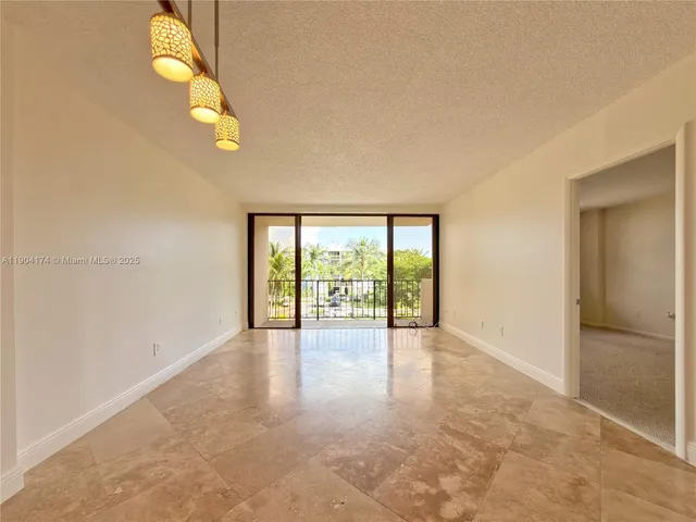 a view of a kitchen with a sink and a refrigerator