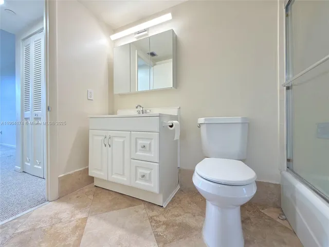 a bathroom view of a toilet and a sink