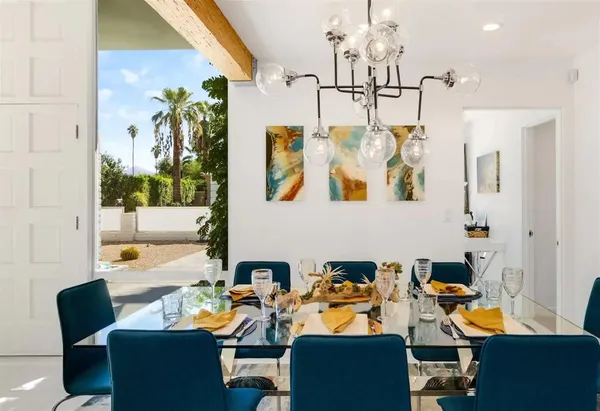 a kitchen with kitchen island a stove a table and chairs in it