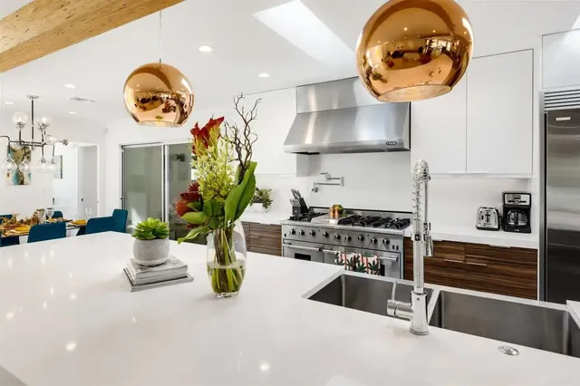a kitchen with stainless steel appliances granite countertop a stove and a large cabinets