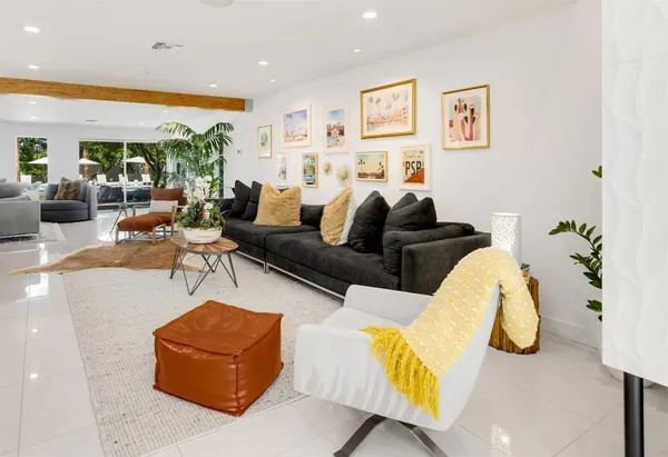 a living room with furniture and wall painting
