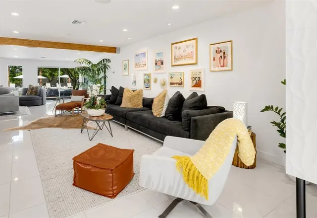 a living room with furniture and wall painting