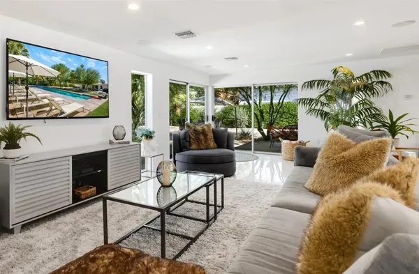 a bedroom with a large bed and a painting on the wall