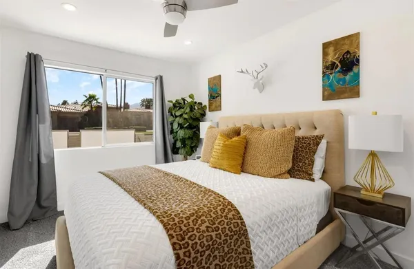 a bedroom with a bed and a potted plant