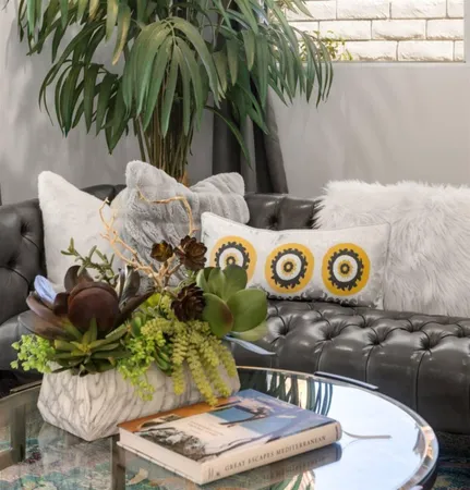 a living room with patio furniture and a floor to ceiling window