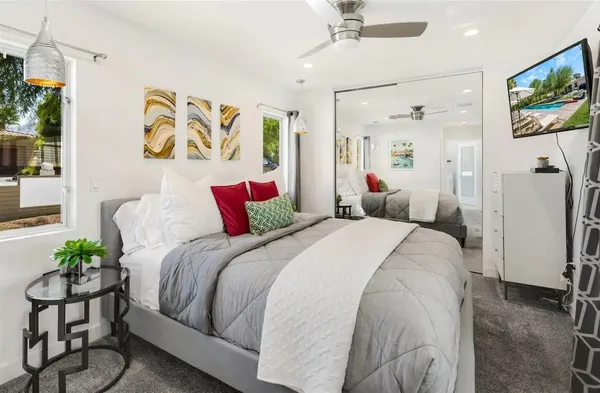 a bed sitting in a bedroom next to a window