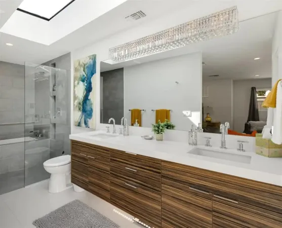 a bathroom with a double vanity sink toilet and shower