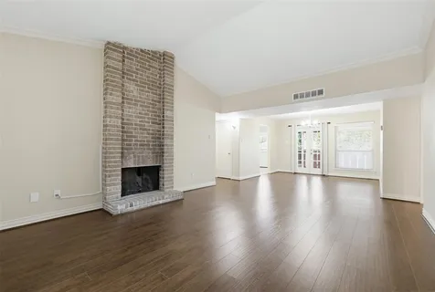 wooden floor in an empty room with a fireplace