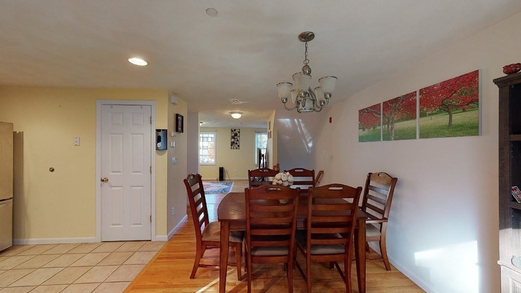 81 Salem Road, Unit 92 Billerica, MA 01821 - Photo 13 of 32 a dining room with furniture and chandelier