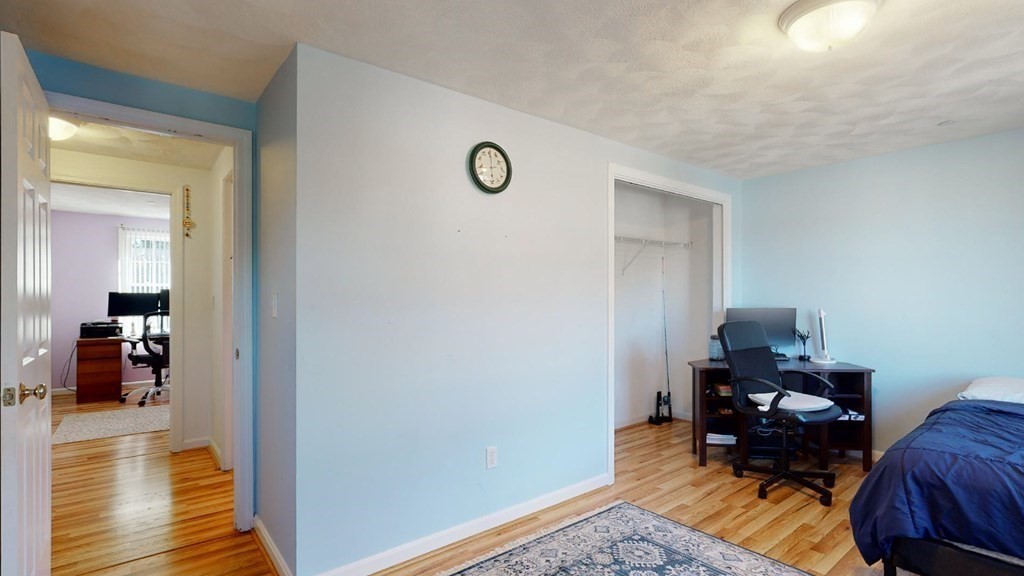 81 Salem Road, Unit 92 Billerica, MA 01821 - Photo 21 of 32 a view of a bedroom with furniture and wooden floor