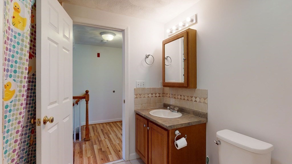 81 Salem Road, Unit 92 Billerica, MA 01821 - Photo 23 of 32 a bathroom with a sink vanity mirror and toilet