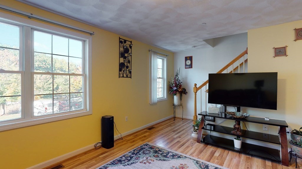 81 Salem Road, Unit 92 Billerica, MA 01821 - Photo 7 of 32 a living room with furniture and a flat screen tv