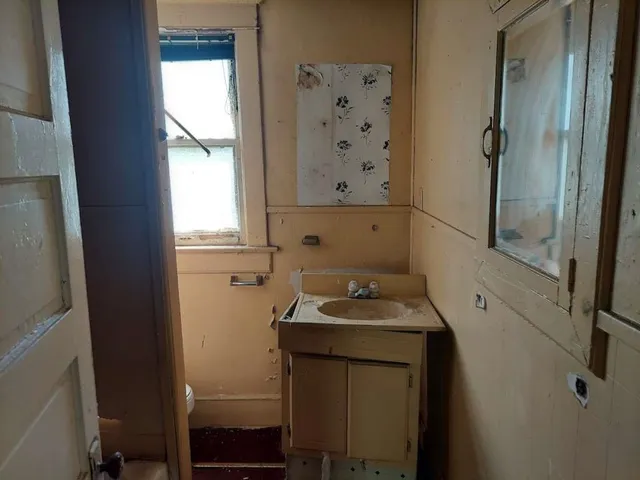 a view of a hallway with a closet and a living room