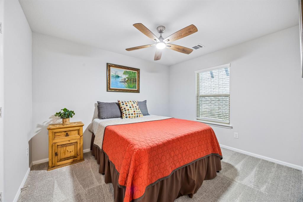 14061 Earlham Street Pilot Point, TX 76258 - Photo 4 of 10 a bedroom with a bed and a chandelier