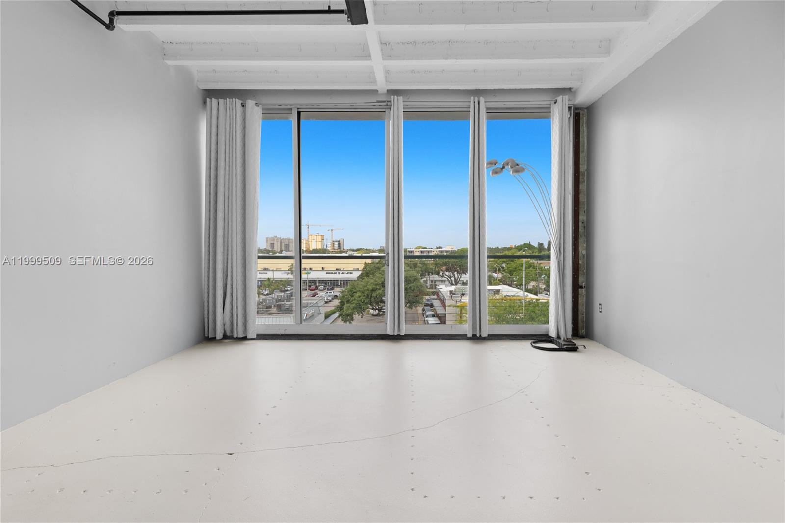 8101 Biscayne Boulevard, Unit R414 Miami, FL 33138 - Photo 7 of 27 a view of room with floor to ceiling window