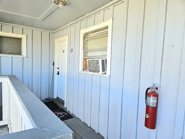 a view of a hallway with closet and front door