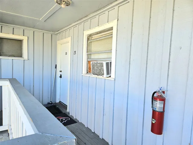 a view of a hallway with closet and front door