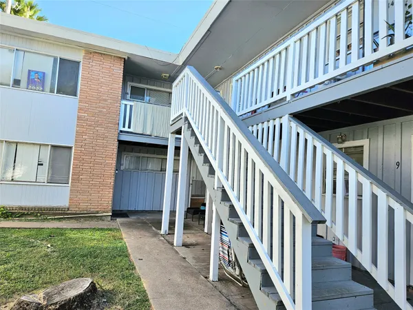 a view of staircase with wooden floor and fence
