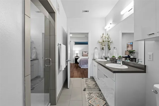 a en suite bathroom with a sink and mirror