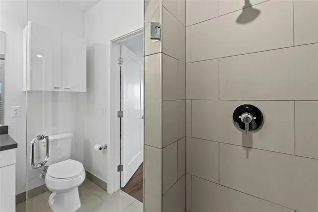 a bathroom with a toilet and a shower