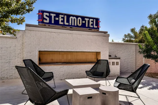 a balcony with table and chairs