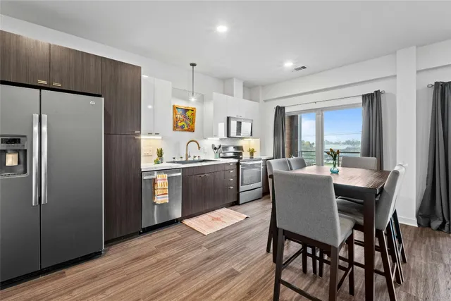 a kitchen with a refrigerator a table and chairs