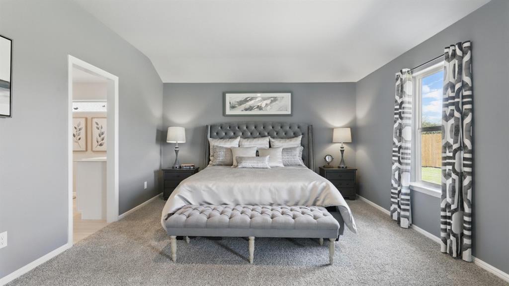 16413 Hudson Pr Way Justin, TX 76247 - Photo 18 of 36 a spacious bedroom with a bed and a table