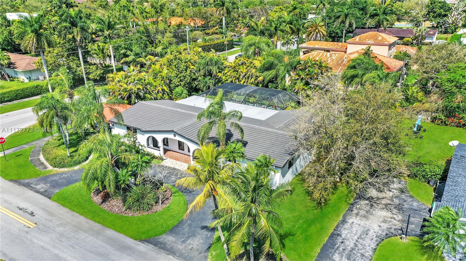 an aerial view of a house with garden space and street view