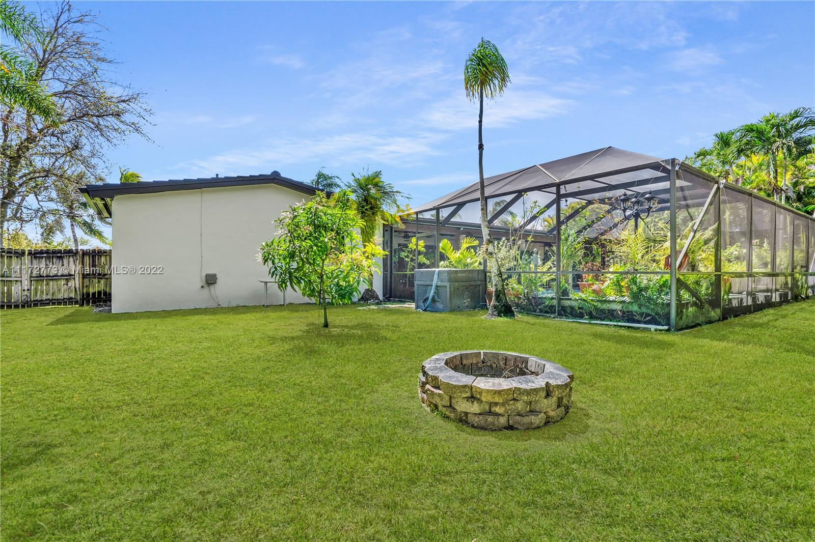 8695 Southwest 110th Street Miami, FL 33156 - Photo 11 of 54 a view of a table and chairs under an umbrella