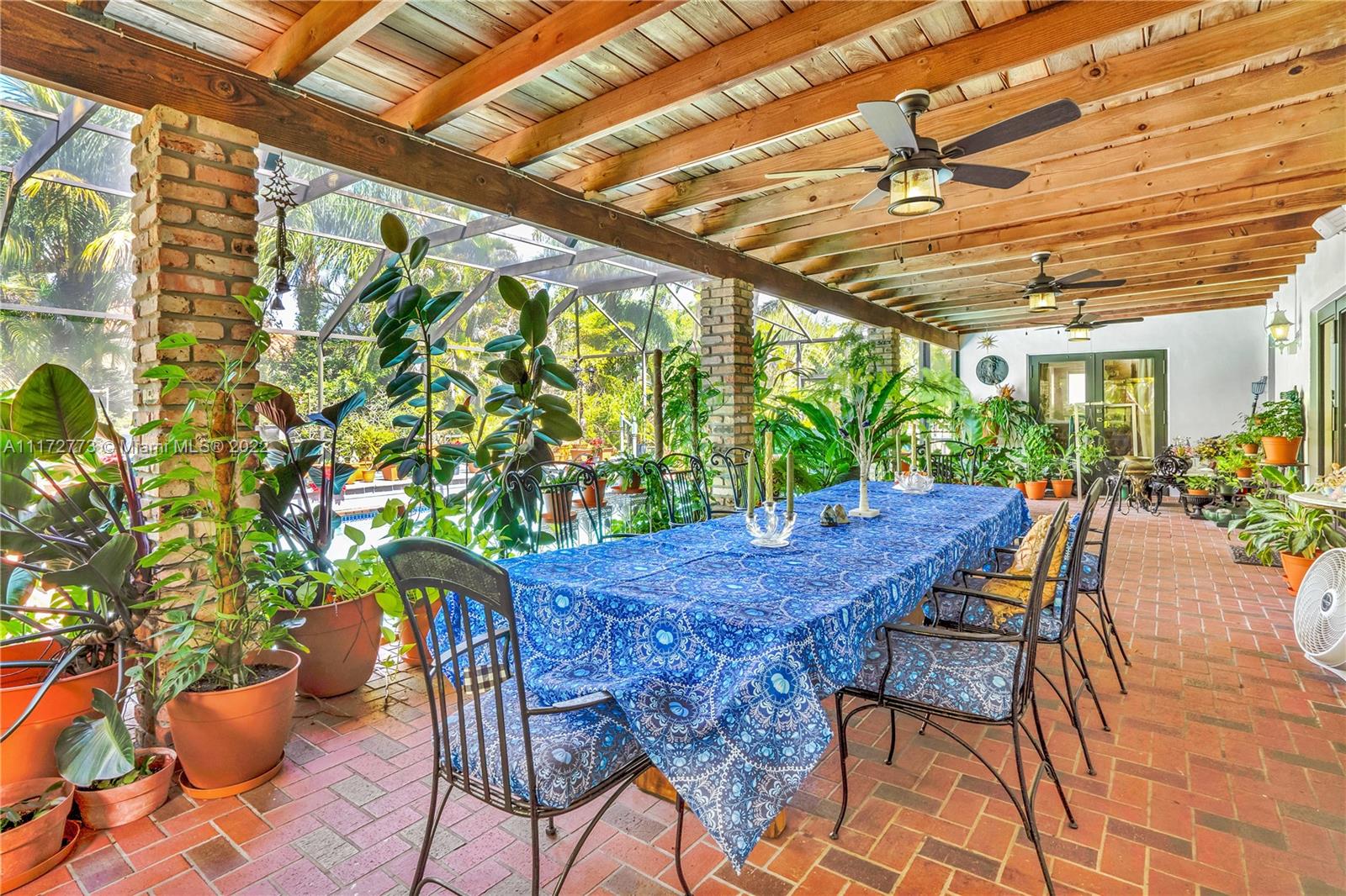 8695 Southwest 110th Street Miami, FL 33156 - Photo 22 of 54 a view of an outdoor space with a table and chairs