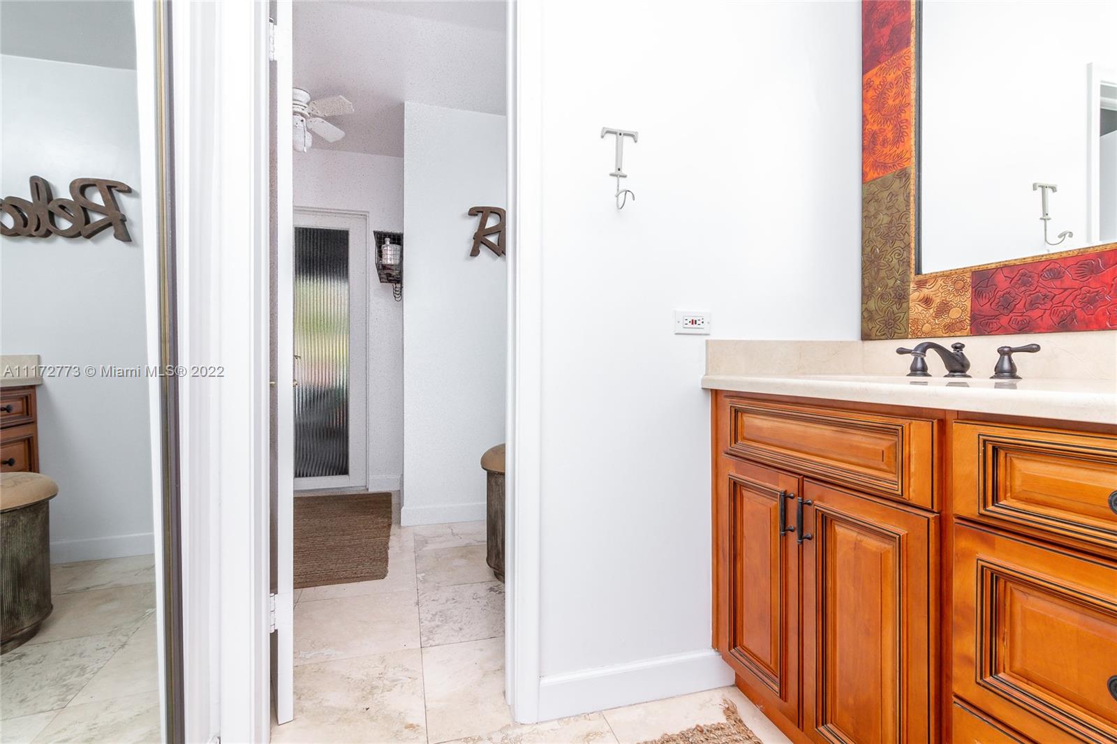 8695 Southwest 110th Street Miami, FL 33156 - Photo 26 of 54 a bathroom with a sink and a mirror