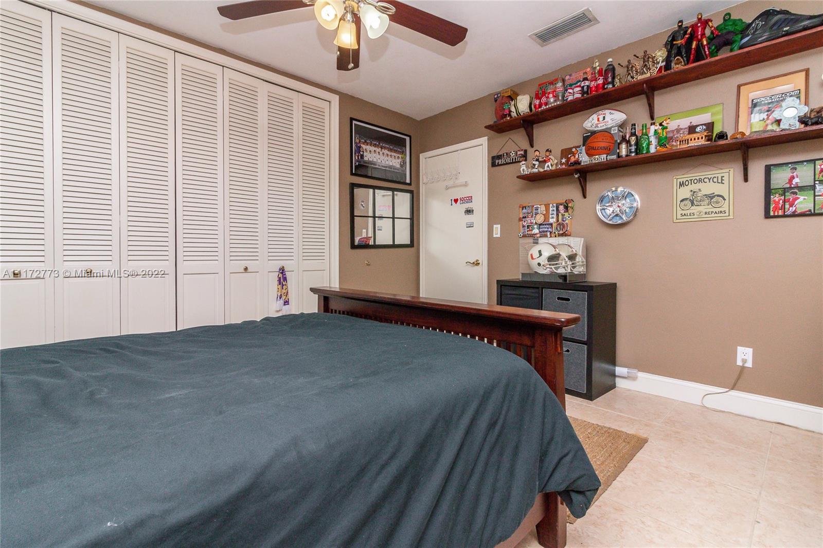 8695 Southwest 110th Street Miami, FL 33156 - Photo 30 of 54 a bedroom with a bed and a window