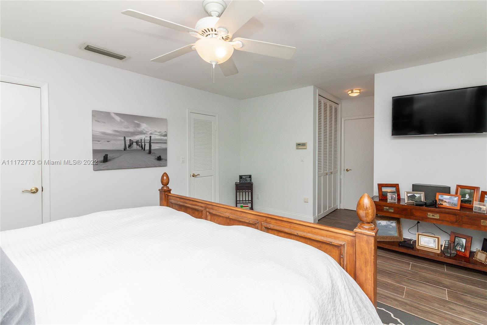 8695 Southwest 110th Street Miami, FL 33156 - Photo 32 of 54 a bedroom with a bed and a flat screen tv