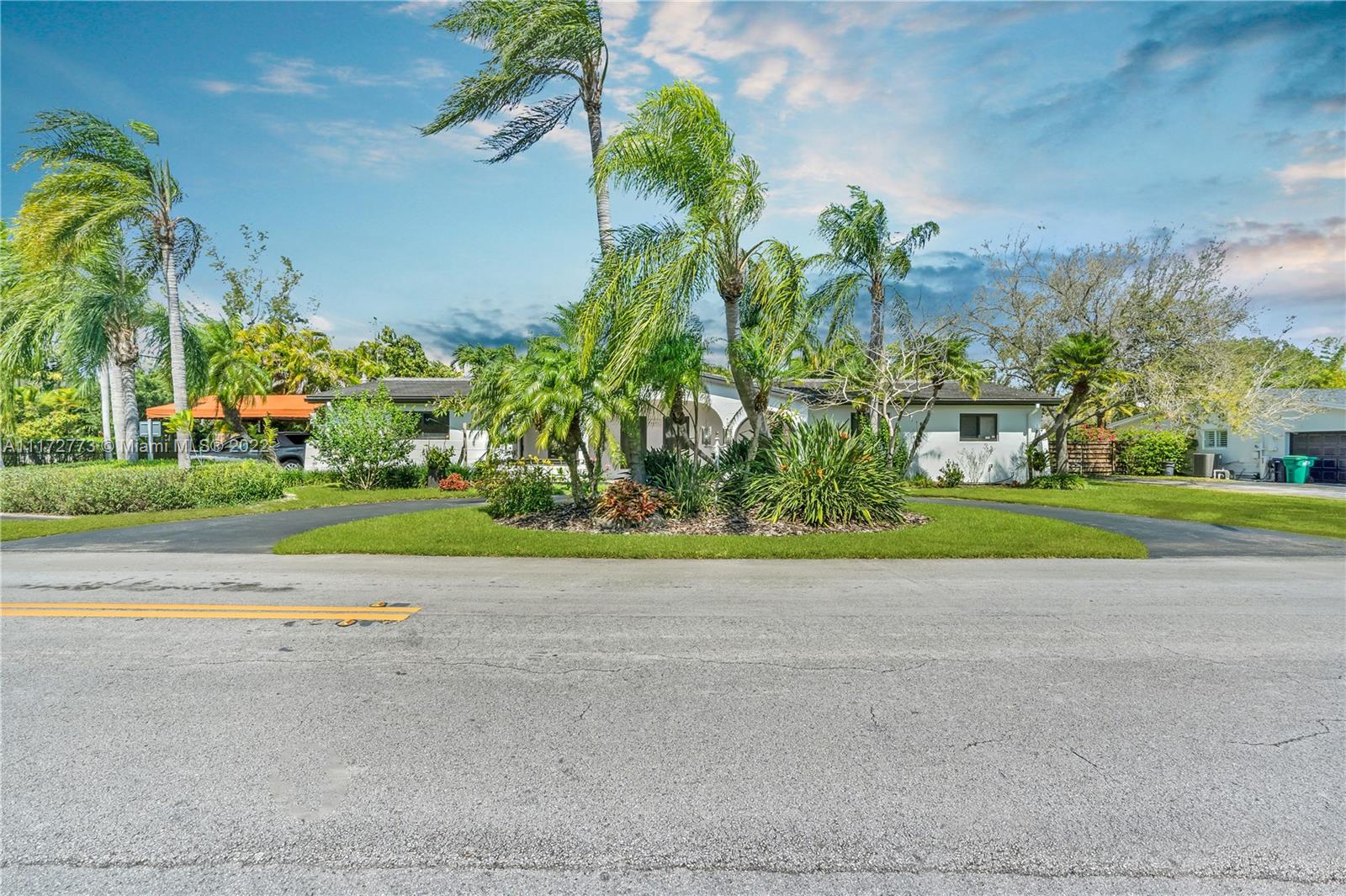 8695 Southwest 110th Street Miami, FL 33156 - Photo 38 of 54 a white house with a yard and plants