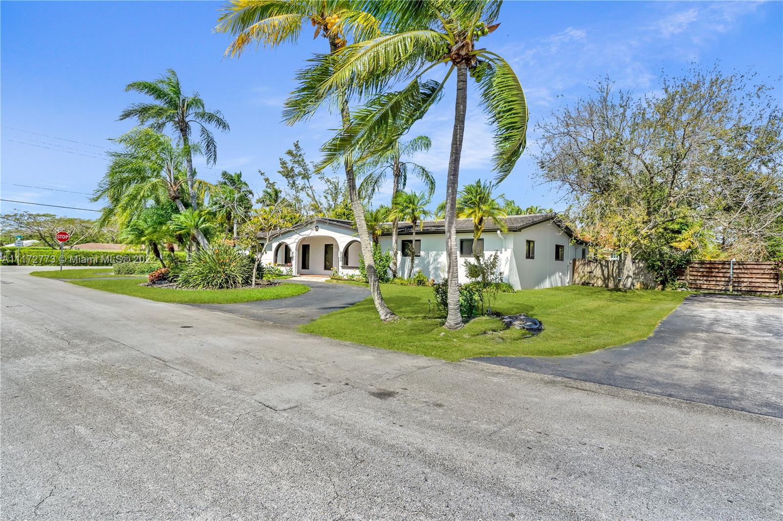 8695 Southwest 110th Street Miami, FL 33156 - Photo 39 of 54 a front view of a house with a yard and trees