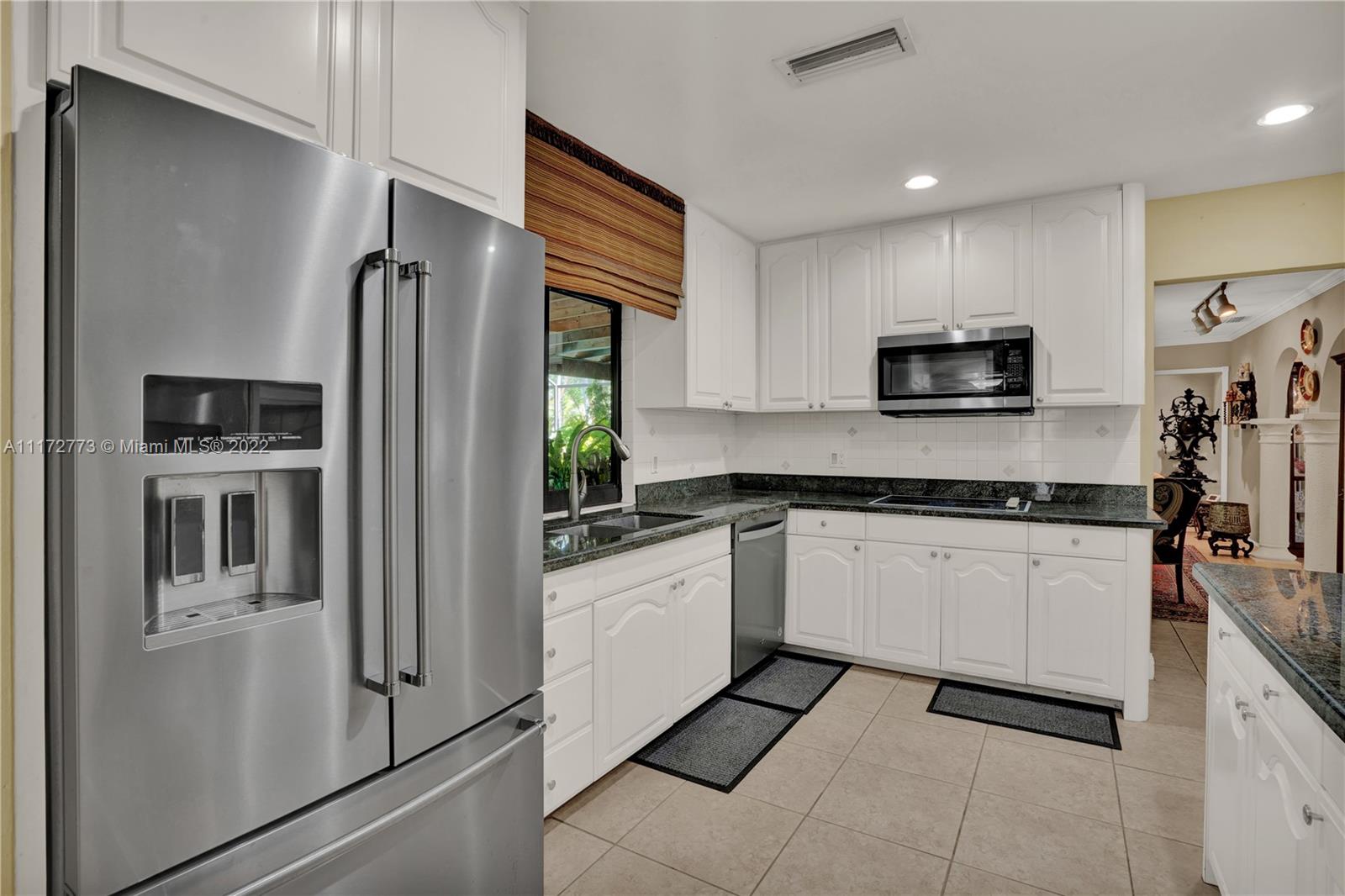 8695 Southwest 110th Street Miami, FL 33156 - Photo 5 of 54 a kitchen with stainless steel appliances granite countertop a refrigerator sink and stove