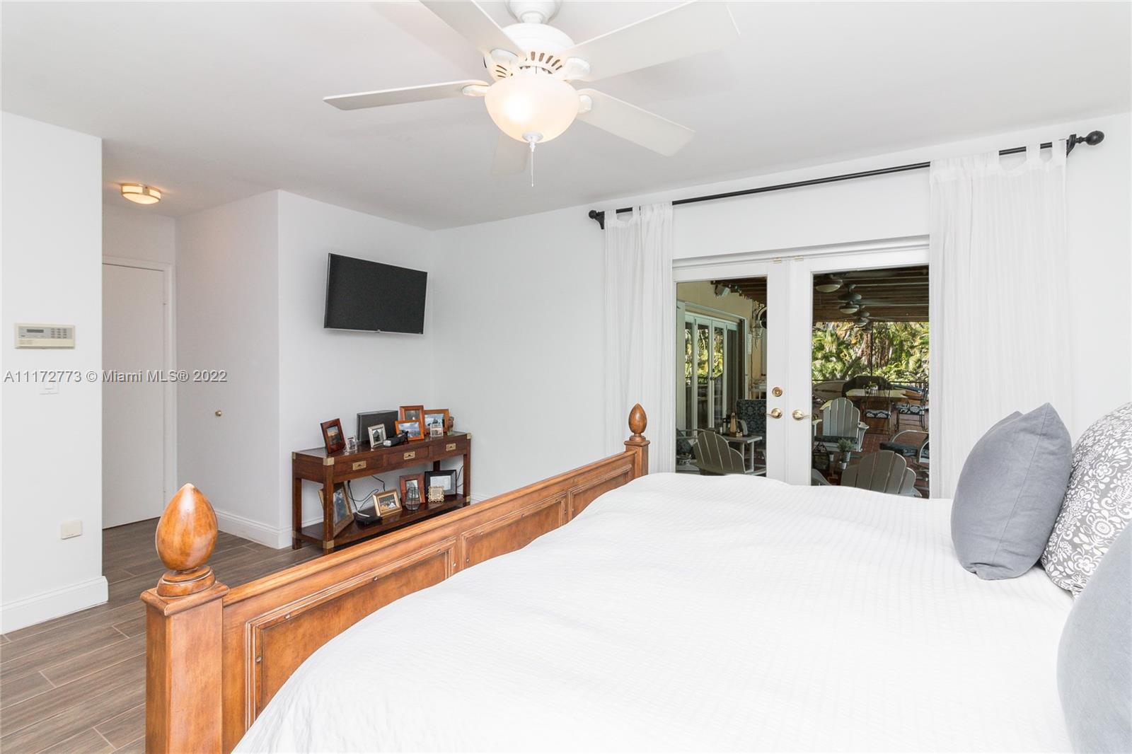 8695 Southwest 110th Street Miami, FL 33156 - Photo 52 of 54 a bedroom with a bed and a flat screen tv