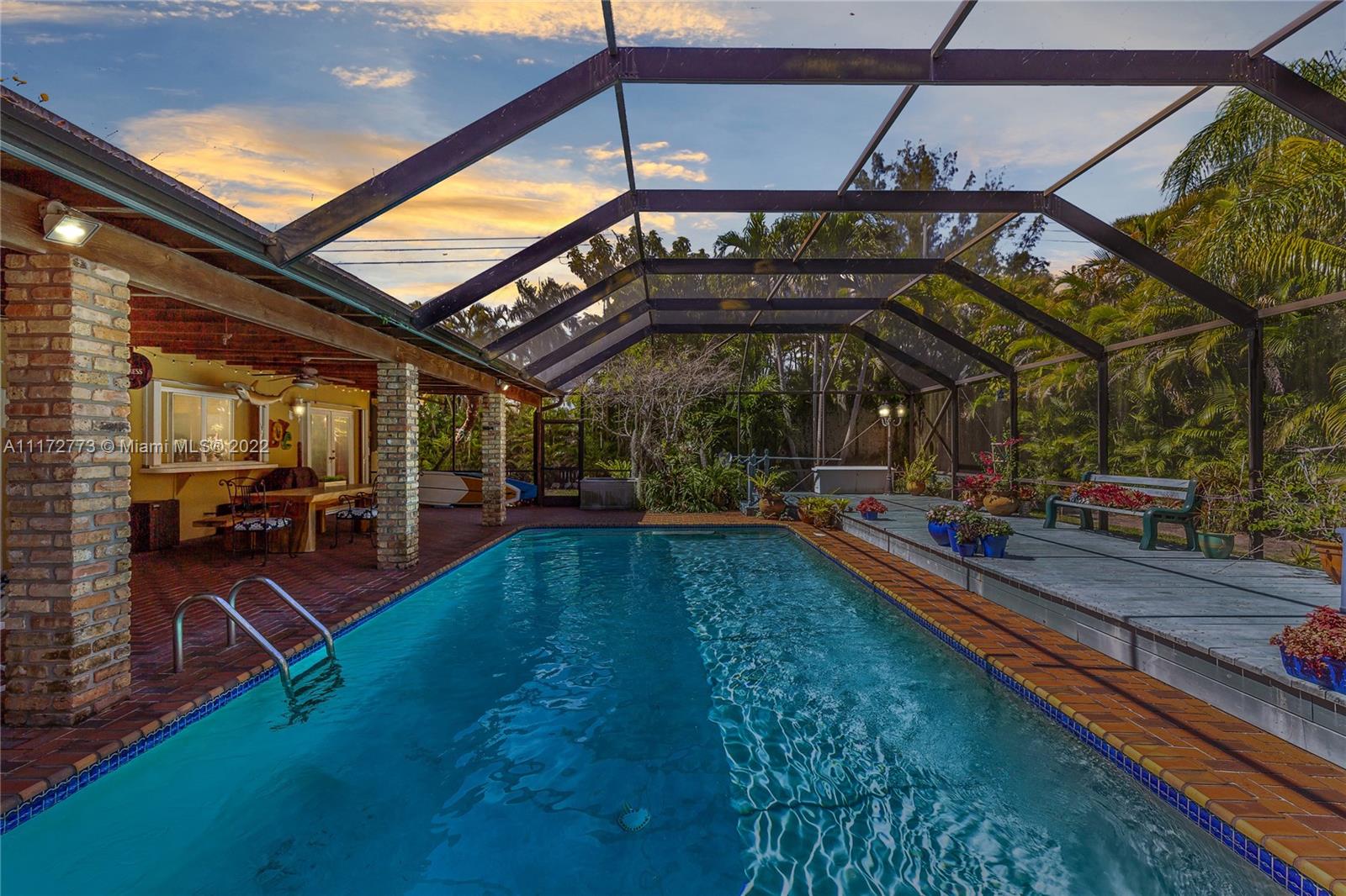 8695 Southwest 110th Street Miami, FL 33156 - Photo 8 of 54 a view of a swimming pool with a patio