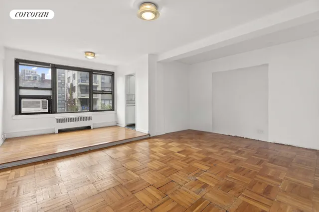 a living room with furniture a wooden floor and a sink