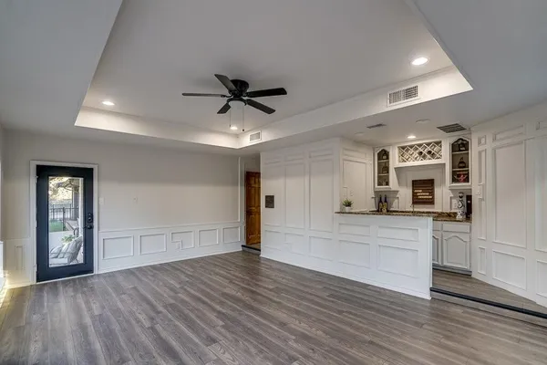 a kitchen with a refrigerator and a stove top oven