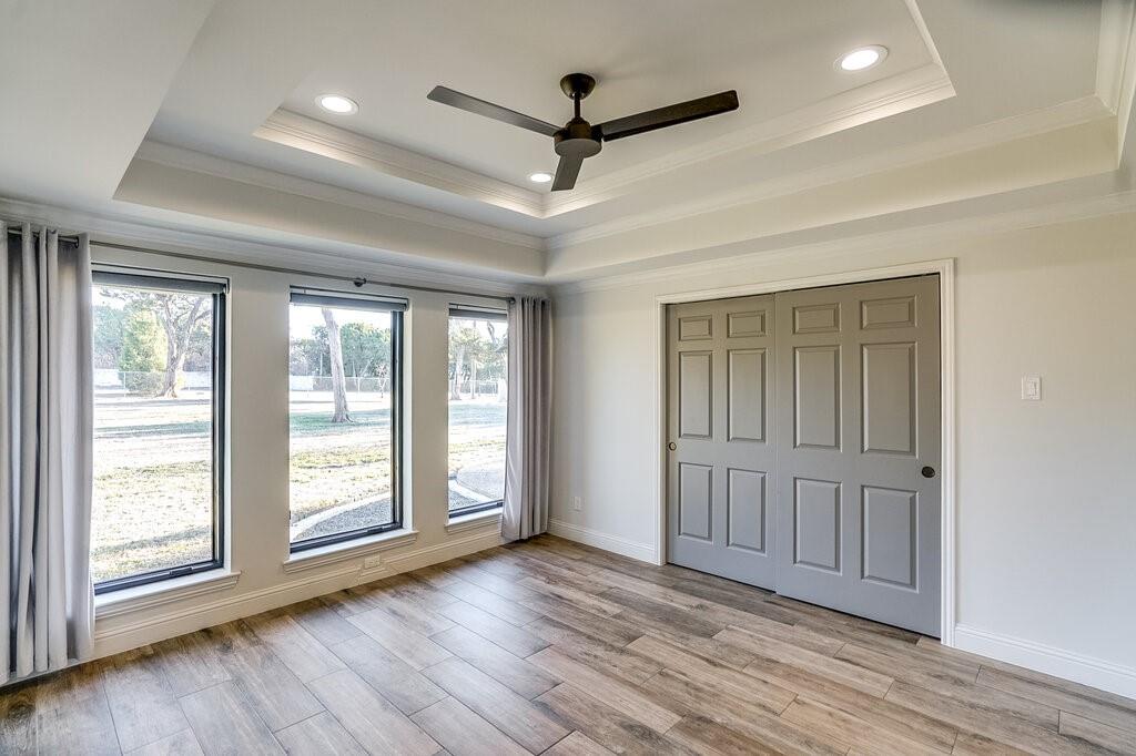 2045 Mansfield Road Cedar Hill, TX 75104 - Photo 14 of 32 an empty room with wooden floor and windows
