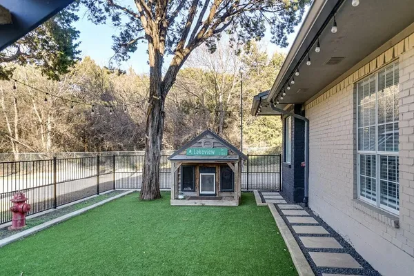 a view of an house with backyard space and balcony