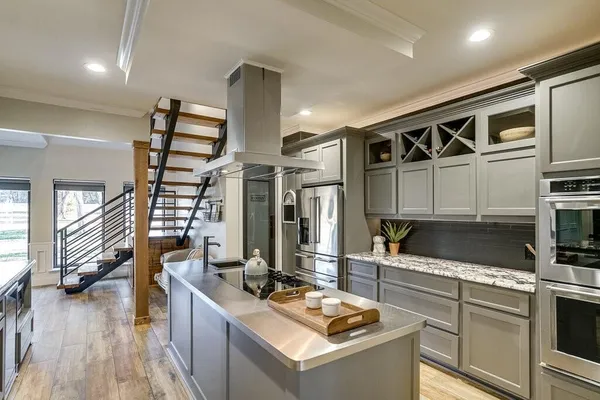 a kitchen with stainless steel appliances granite countertop a stove and a sink
