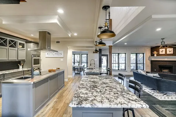 a living room with fireplace furniture flat screen tv and windows