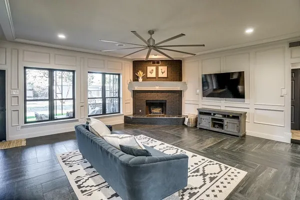 a living room with furniture and a fireplace or television