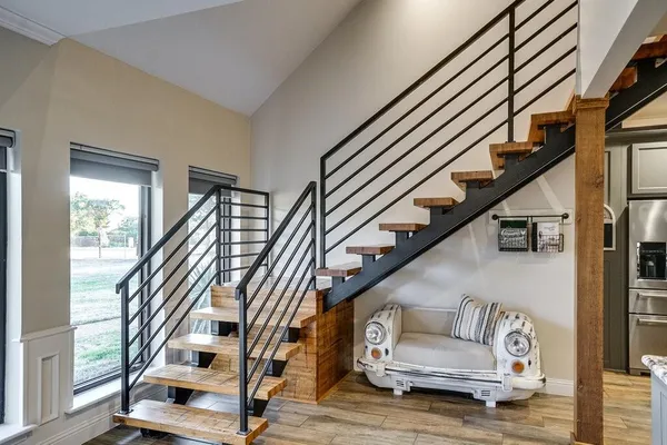 a view of entryway and hall with wooden floor