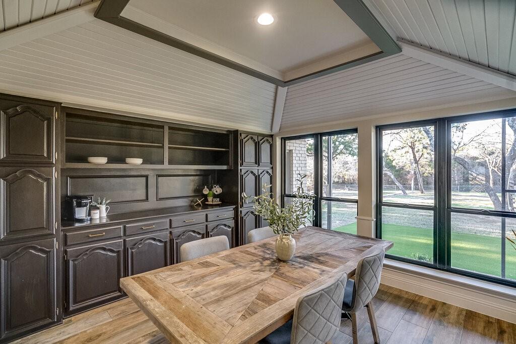 2045 Mansfield Road Cedar Hill, TX 75104 - Photo 8 of 32 a kitchen with a table chairs and wooden floor