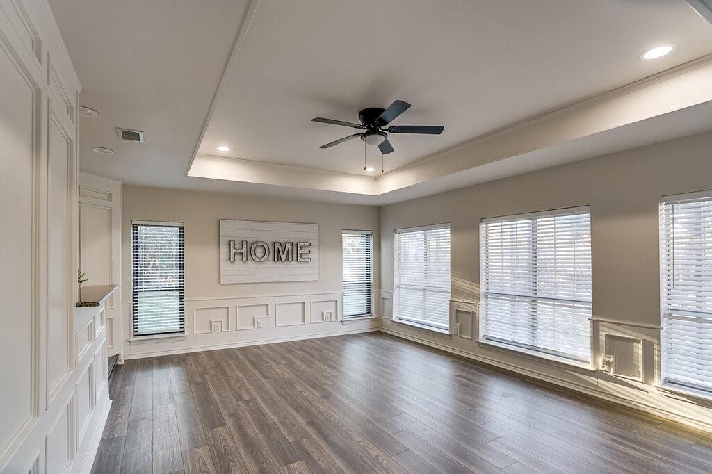 2045 Mansfield Road Cedar Hill, TX 75104 - Photo 9 of 32 a view of an empty room with a window and wooden floor
